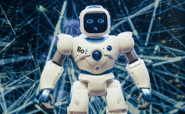 A modern humanoid robot with luminous features set against a digital network backdrop.